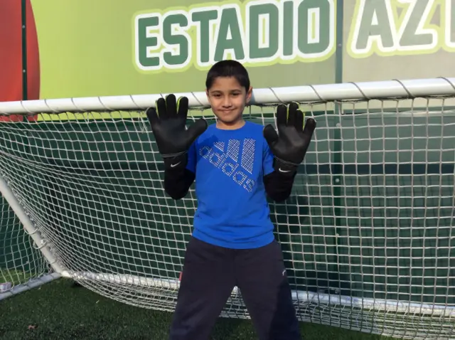 Canaries goalkeeper's son wearing his gloves