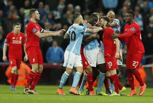 Adam Lallana clashes with Manchester City"s Yaya Toure