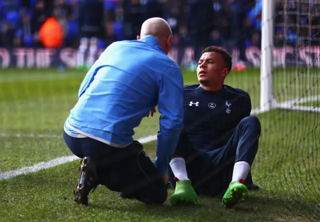 Dele Alli of Tottenham Hotspur receives treatment in the warm up