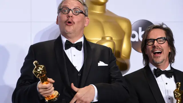 Josh Singer and Tom McCarthy pose with their trophies for Original Screenplay for Spotlight