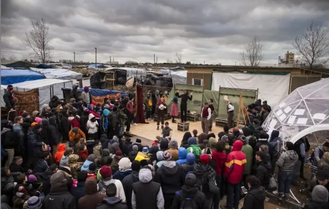 Actors from Shakespeare's Globe perform Hamlet to migrants at the Good Chance Theatre Tent in the Jungle Refugee Camp