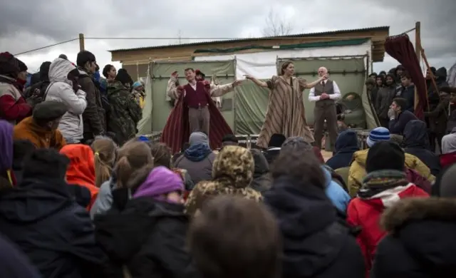 Actors from Shakespeare's Globe perform Hamlet to migrants at the Good Chance Theatre Tent in the Jungle Refugee Camp