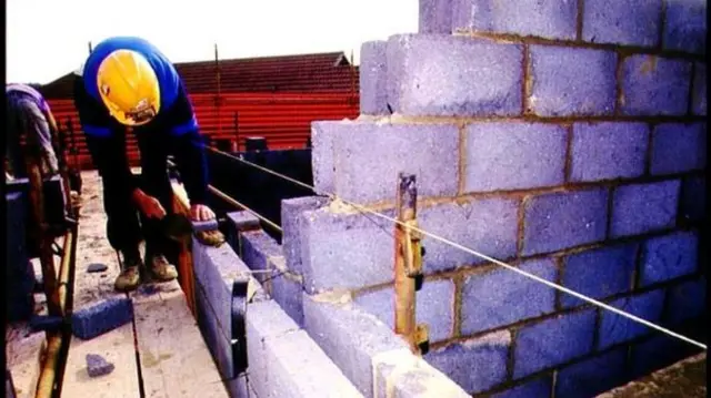 Builders working on house