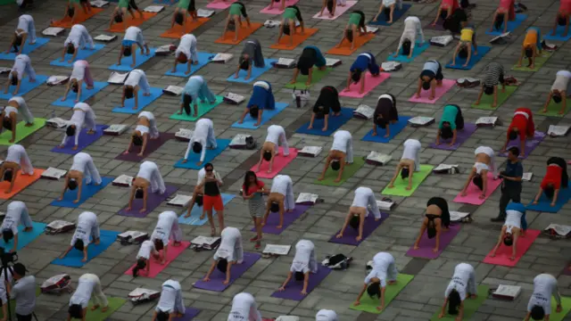 Lots of people practicing yoga