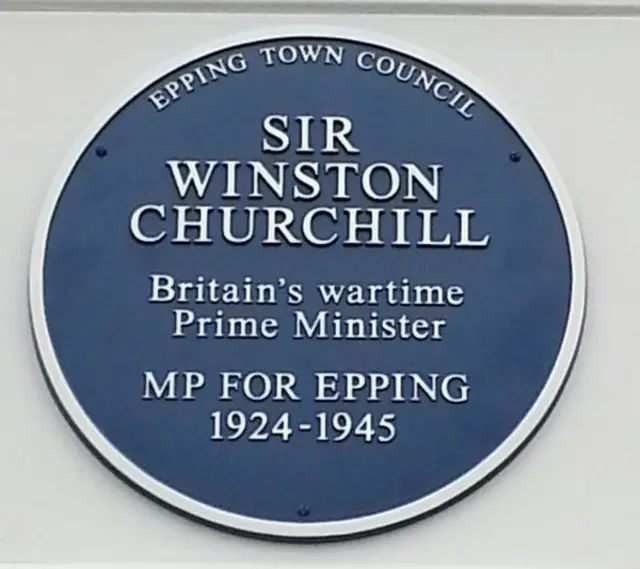 Blue plaque showing: 'Sir Winston Churchill, Britain's wartime Prime Minister. MP for Epping 1924-1945'