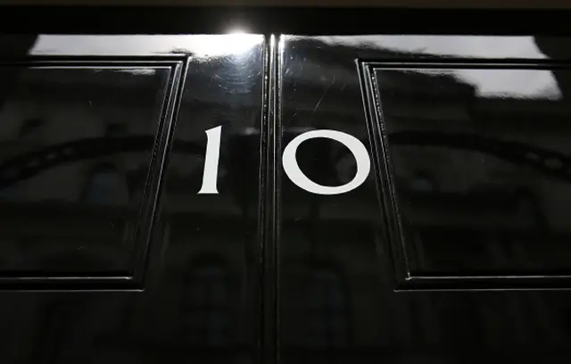 Afternoon sun is reflected off the door to number 10 Downing Stree