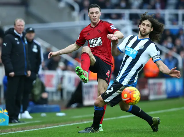 Fabricio Coloccini of Newcastle United tackles James Chester of West Bromwich Albion