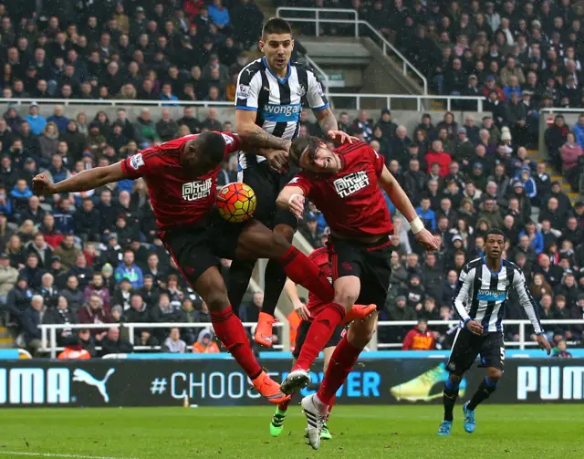 Aleksandar Mitrovic of Newcastle United competes for the ball against Victor Anichebe and Jonas Olsson