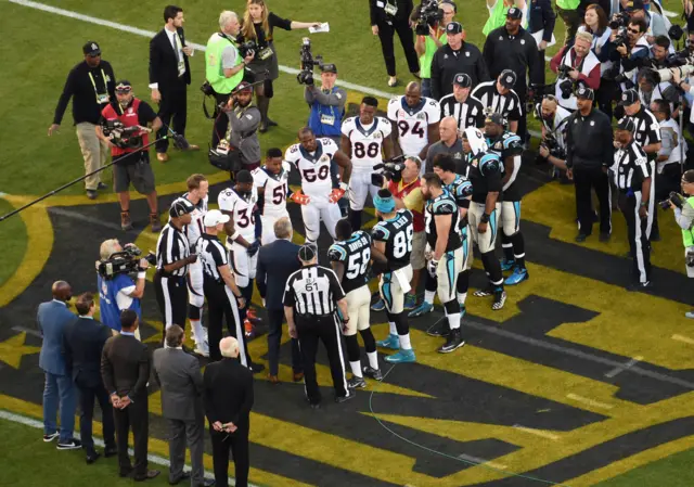 Carolina Panthers and the Denver Broncos line-up fort the coin toss