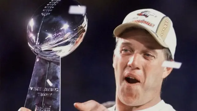 John Elway lifting the Lombardi trophy for the Denver Broncos