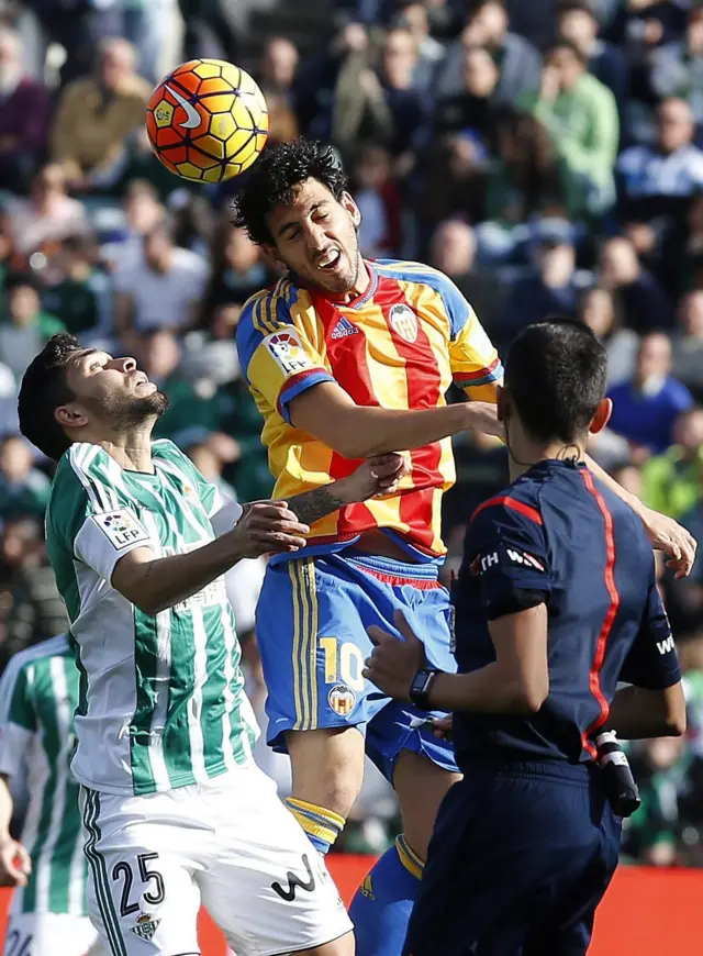 Valencia's Dani Parejo heads the ball