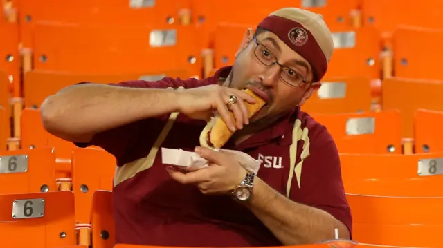 Fan eats hot dog