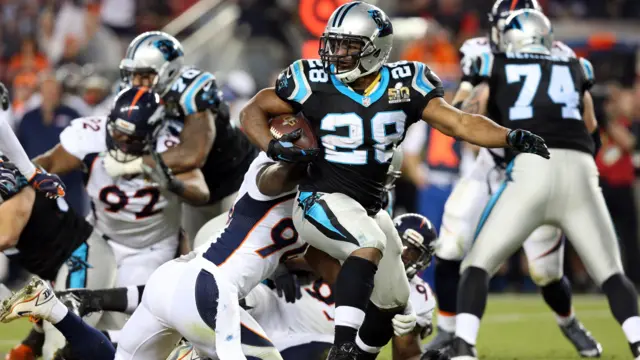 Jonathan Stewart runs with possession