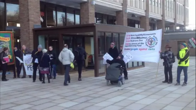 Disabled people protesting outside County Hall