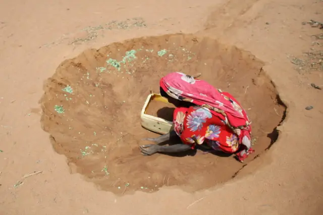 A Somalian refugee collects sand outside her hut to act as building material on the edge of the Dagahaley refugee camp which makes up part of the giant Dadaab refugee settlement on July 21, 2011 in Dadaab, Kenya