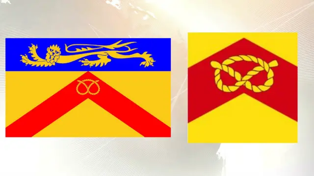 The county council's flag to the left, the competing flag to the right