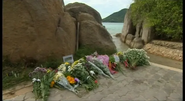 Flowers laid in tribute at the beach in Thailand