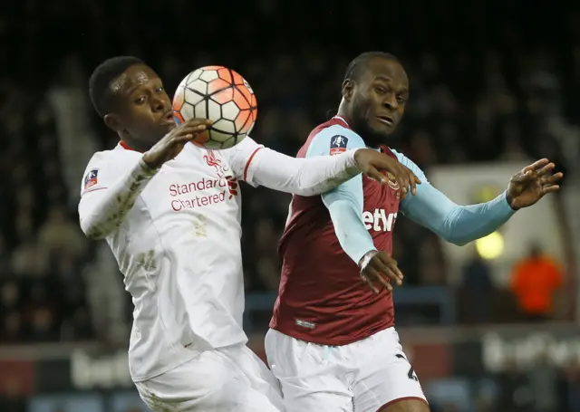 Victor Moses vies for the ball with Liverpool's Divock Origi