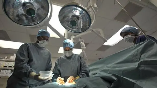 Doctors working on orgn transplant in theatre