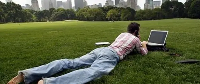 Man on laptop in park