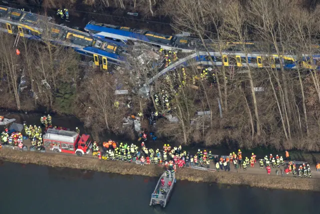 Firefighters and emergency doctors work at the site of a train accident near Bad Aibling, southern Germany, on 9 February 2016