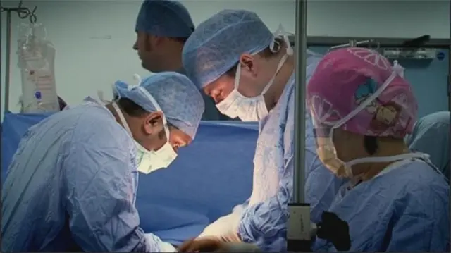 Doctors performing transplant in theatre