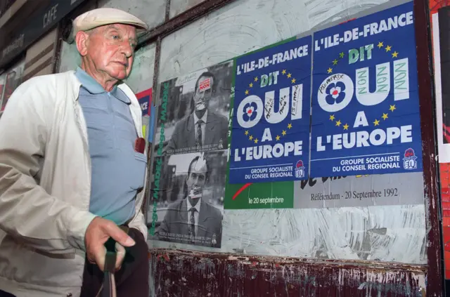 Man walks past signs about French referendum on Maastricht in 1992