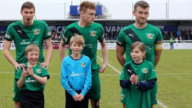 Nantwich Town players with mascots