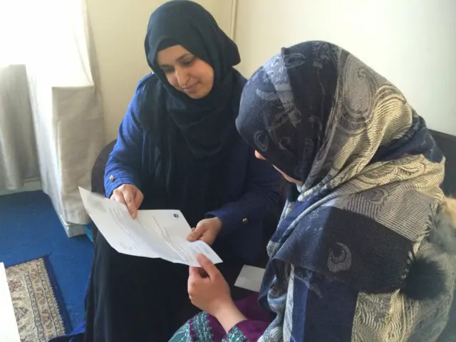 Community worker with the mother (right)