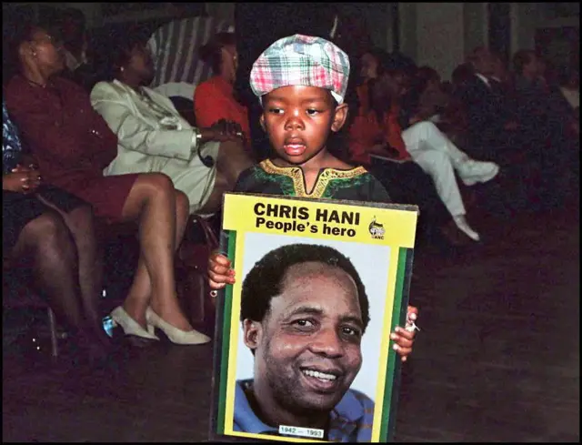 Archive shot of a child holding a poster of South African politician Chris Hani