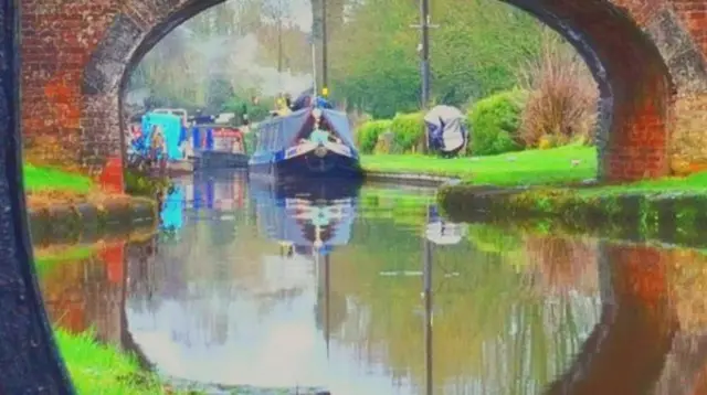 Boat going down canal