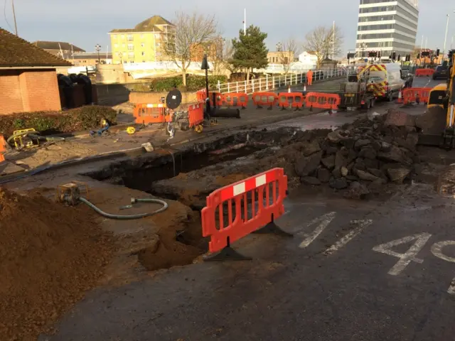 A hole in the road, where the water mains burst
