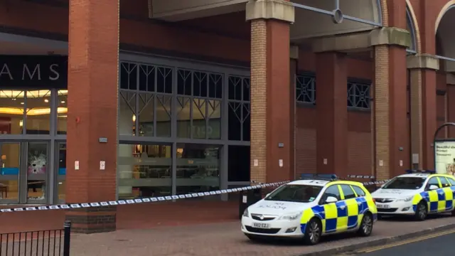 Police cars and police tape outside Potteries Shopping Centre