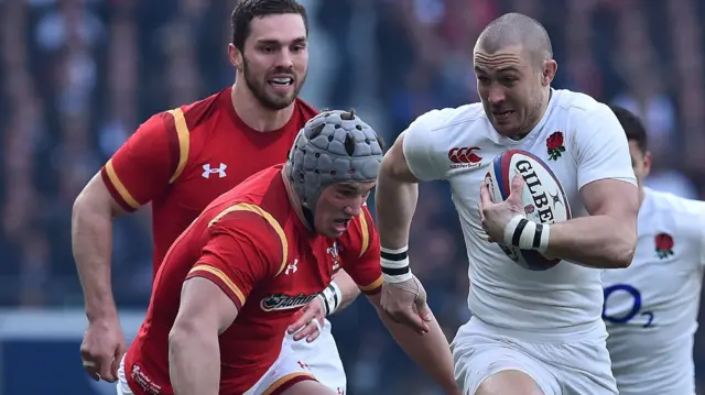 Wales' Jonathan Davies tackles England's Mike Brown