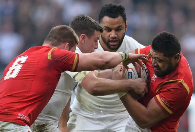 Taulupe Faletau is tackled by George Ford