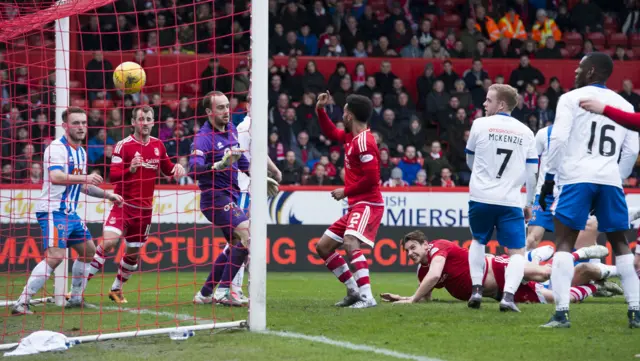 Ash Taylor (grounded, right) scores for Aberdeen