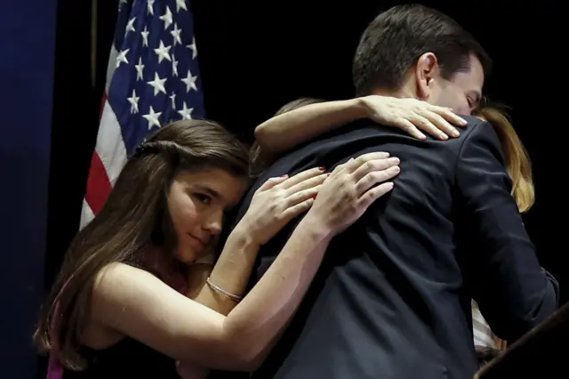 Marco Rubio hugs his family after he announced that he is suspending his campaign at an event in Miami, Florida