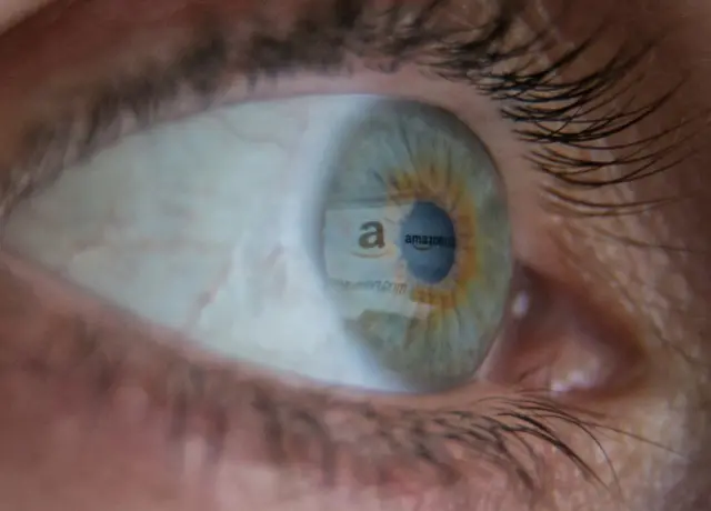 Online retailer Amazon logo reflected in eye