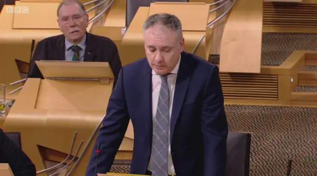 SNP MSP Rob Gibson listens as the rural affairs secretary praises him