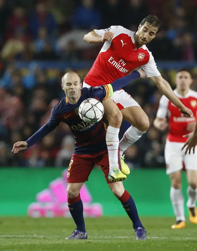 Mathieu Flamini fouls Andres Iniesta