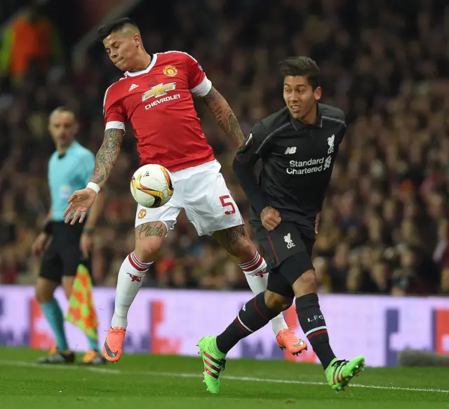 Marcos Rojo and Roberto Firmino