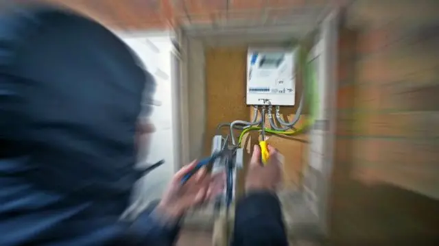 stock photo of man fiddling with wires