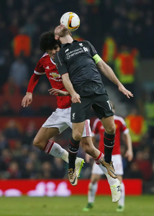 Jordan Henderson battles for the ball