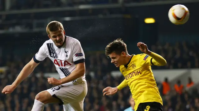 Eric Dier heads the ball towards goal