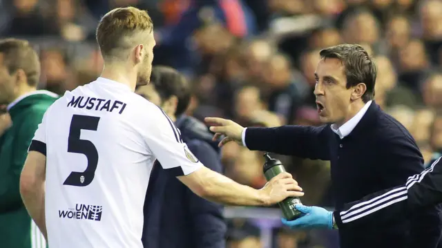 Valencia boss Gary Neville gives instructions to Shkodran Mustafi