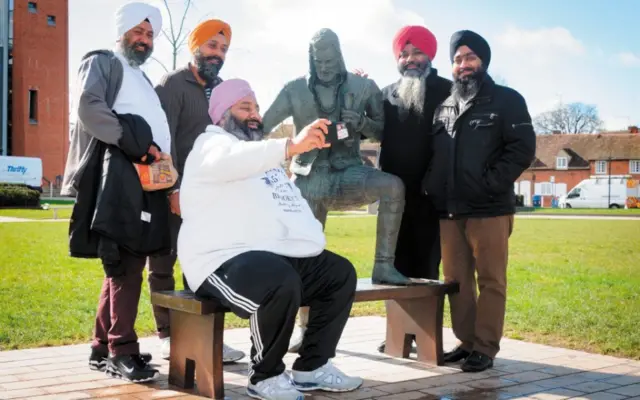 Group saking a selfie with Young Will statue