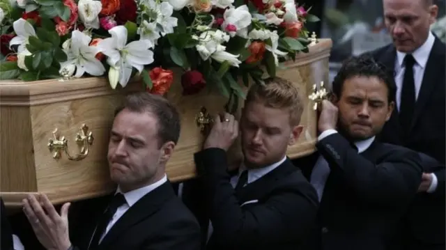 Coronation Street cast members carry Tony Warren's coffin at his funeral