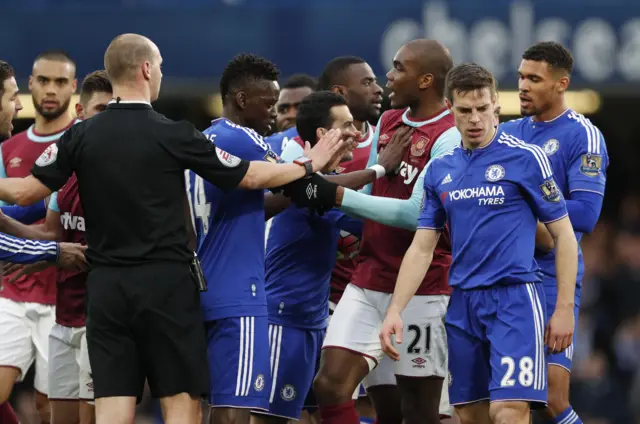 The players clash in the dying seconds at Stamford Bridge