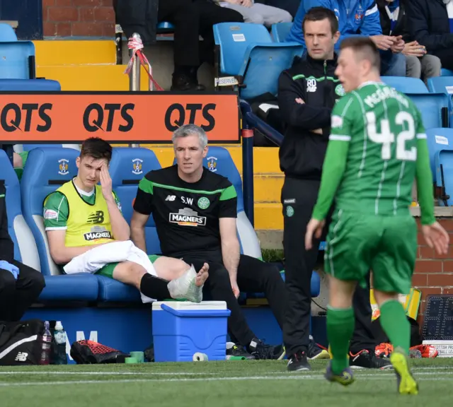 Kieran Tierney rests his injured right ankle prior to half-time.