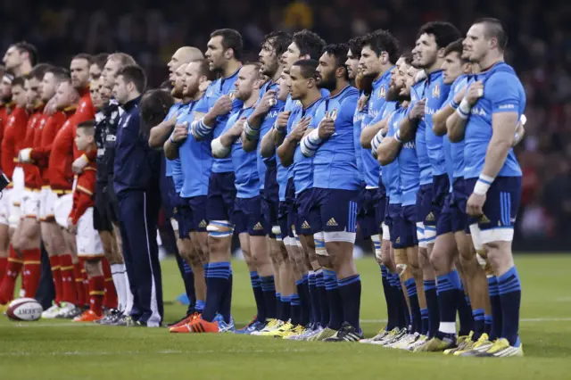 The Italian players sing the national anthem